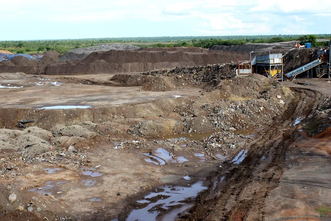THE SCARS IN THE EARTH OF AN OPEN CAST MINE SITS UNDER A CLOUDY SKY