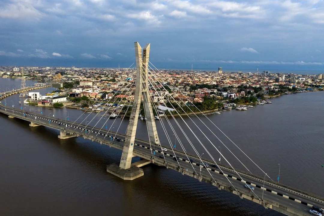 A LONG ROAD BRIDGE CROSSES A LAGOON IN A CITY