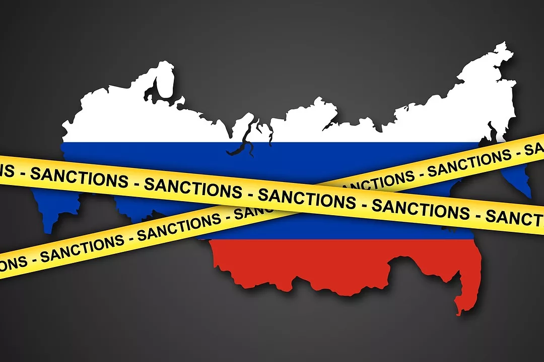 A MAP CUT-OUT OF RUSSIA HAS SANCTION TAPE ACROSS IT