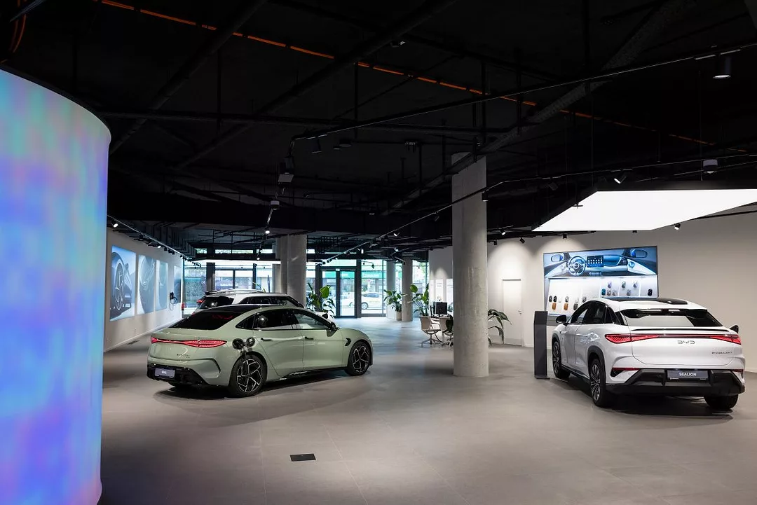 SEVERAL CARS SIT IN AN UNDERGROUND GARAGE