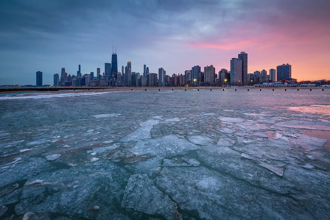 Frozen waters in front of the Chicago downtown skyline at sunset