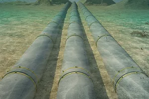 Three large metal underwater pipelines on a seafloor