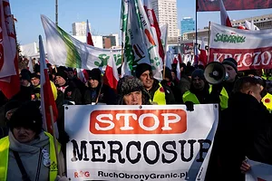 A GROUP OF PEOPLE HOLD UP BANNERS