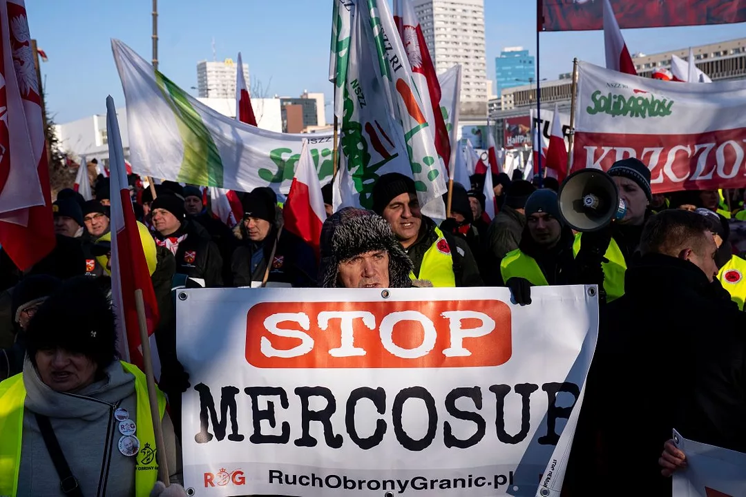 A GROUP OF PEOPLE HOLD UP BANNERS