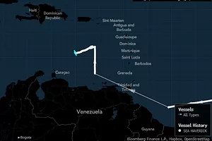 A DARKENED MAP OF THE CARIBBEAN AND AMERICAS SHOWS A BRIGHT BLUE LINE CHARTING A SHIP'S COURSE