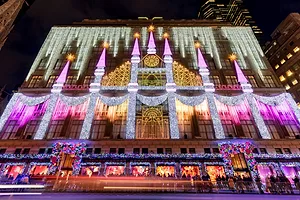 The front of Saks Fifth Avenue Department Store is decked with a Christmas light show and holiday season window displays.