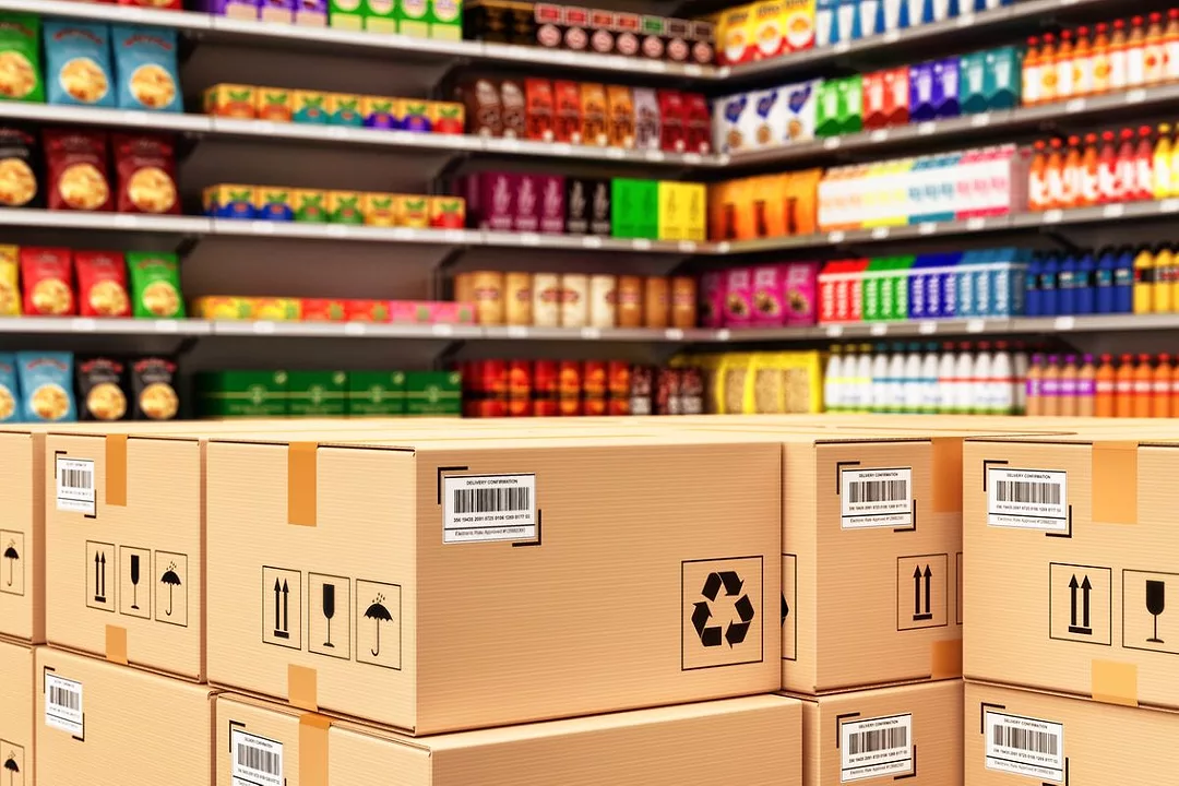 BRIGHTLY PACKAGED GOODS SIT ON SHELVES IN FRONT OF LARGE BROWN BOXES