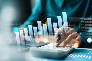 Businesswoman use laptop and calculator analyzing company growth