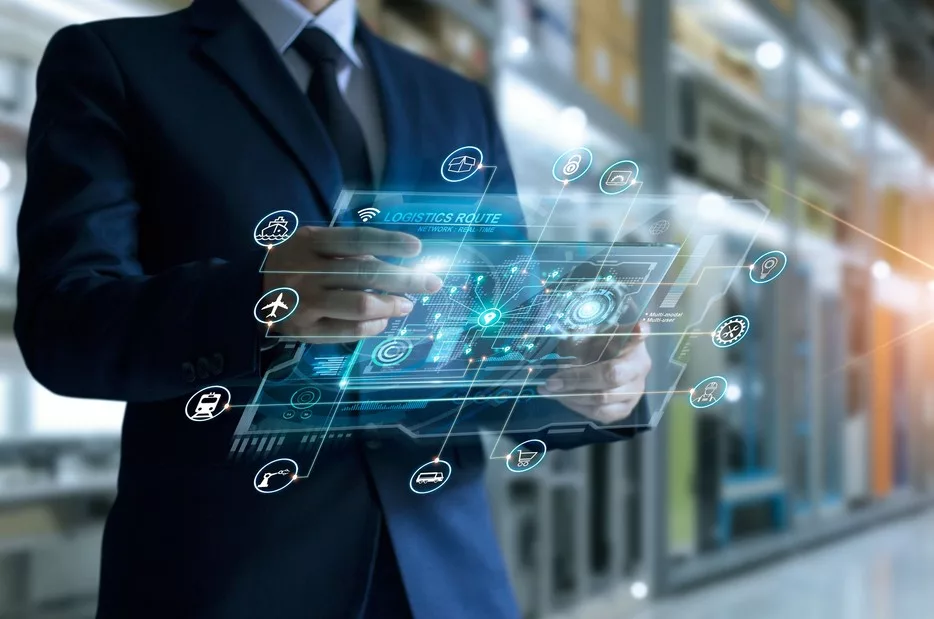 Businessman holding virtual interface panel of global logistics network distribution and transportation in a warehouse