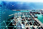 supply-chain-data-iStock-2190857943.jpg An overhead view of a shipping port stacked with containers, with stylized lines forming a grid connecting ships and berths