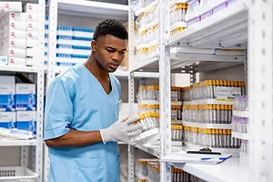 Nurse taking inventory of medical supplies in a hospital.