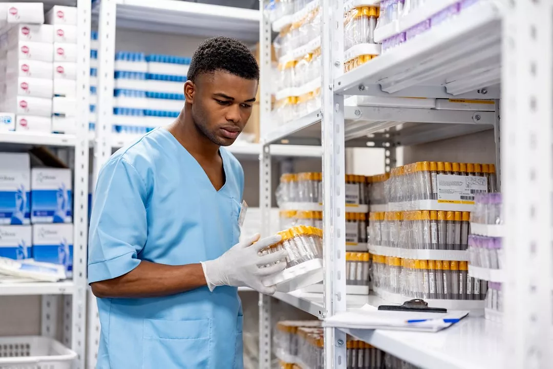 Nurse taking inventory of medical supplies in a hospital.