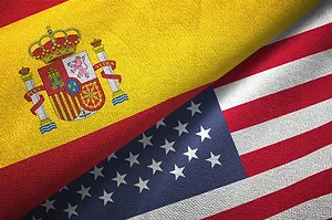 THE FLAGS OF SPAIN AND THE US ARE FOLDED SIDE BY SIDE