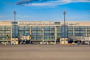 A GLASS-FRONTED AIRPORT TERMINAL