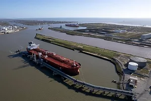 A red ship docked at a port