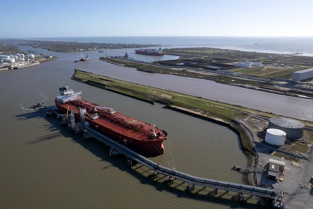 A red ship docked at a port
