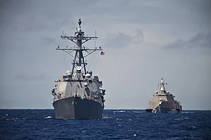 A pair of grey U.S. Navy destroyers at sea