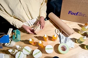 AN AERIAL SHOT OF SOMEONE PACKING UP CONSUMER GOODS FOR SHIPPING