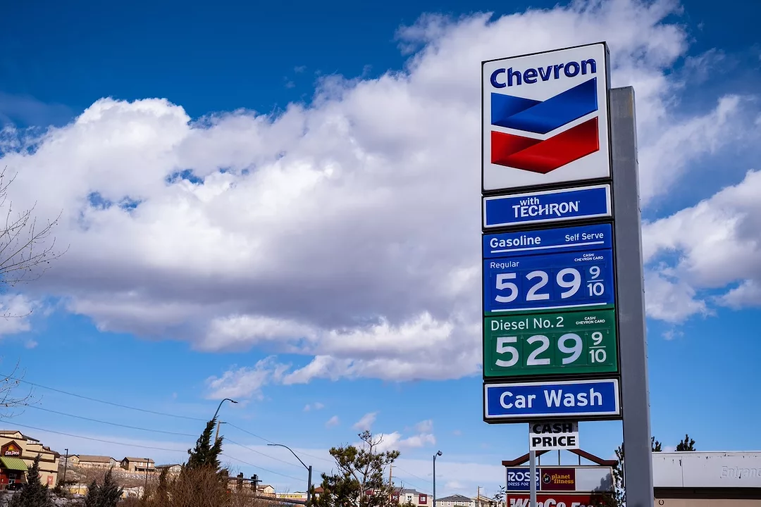 A blue Chevron gas station sign depicting gas prices over $5 a gallon