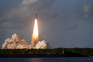 A ROCKET LAUNCHES IN A CLOUD OF SMOKE AND FLAME