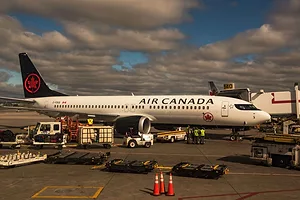 AN AIR CANADA PLANE SITS ON THE TARMAC