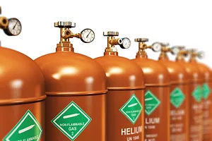 A ROW OF TANKS CONTAINING GAS ARE LABELED HELIUM AND NON-FLAMMABLE GAS