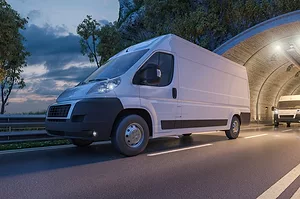 Several Delivery Vans Passing through a Tunnel