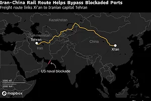 A MAP IN BLACK OF EURASIA SHOWS A BRIGHT ORANGE LINE GOING FROM IRAN TO CHINA