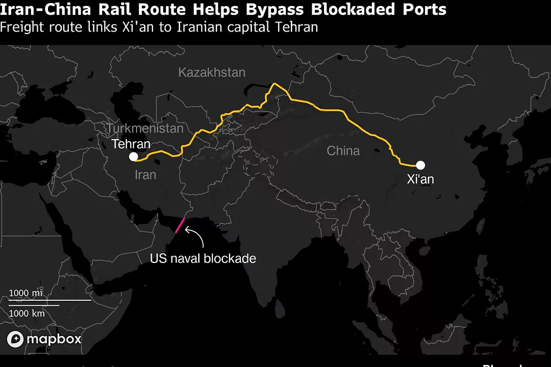 A MAP IN BLACK OF EURASIA SHOWS A BRIGHT ORANGE LINE GOING FROM IRAN TO CHINA