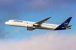 A LARGE AIRCRAFT BEARING THE LUFTHANSA LOG FLIES ABOVE FLUFFLY CLOUDS