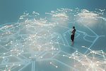 oung man walking and listening to music in VR environment of bright lines stretching out in enormous complexity