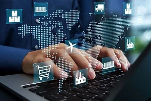 HANDS TYPE ON A KEYBOARD UNDER A SUPER IMPOSED DIGITIZED MAP OF THE WORLD, ALONG WITH IMAGES OF A SHIP, A SHOPPING CART AND OTHER SYMBOLS OF INTERNATIONAL LOGISTICS