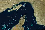 A MAP OF THE STRAIT OF HORMUZ SHOWING DOZENS OF BLUE DOTS DISTRIBUTED THROUGHOUT THE WATERWAY