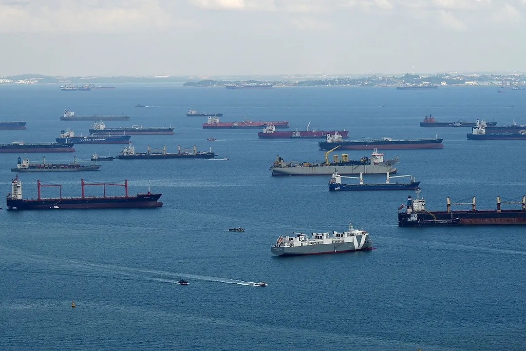 A group of container ships at sea, sitting in the Strait of Malacca