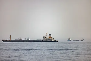 AN OIL TANKER VESSEL AT SEA UNDER A GREY SKY