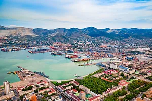 Novorossiysk city aerial panoramic view showing a port and mountains in the background