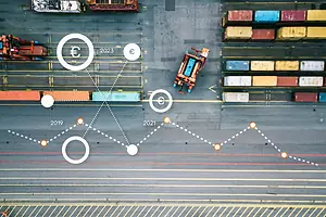 An overhead view of a port, with stacks of containers and vehicles moving through rows