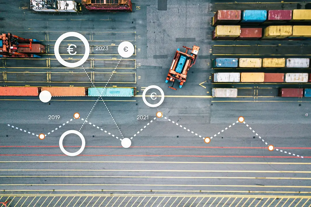 An overhead view of a port, with stacks of containers and vehicles moving through rows