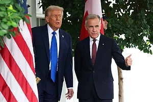 TWO MEN IN DARK SUITS GESTURE TOWARDS AN UNSEEN OBJECT IN FRONT OF A FURLED AMERICAN FLAG