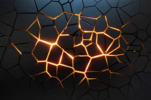 A BLACK SURFACE IS FACTURED, SHOWING BRIGHT FIRE BEHIND