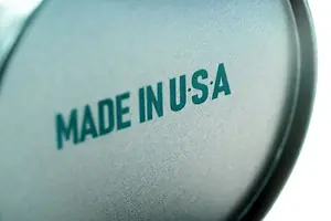 MADE IN USA IS STAMPED ON THE BOTTOM OF A ROUND OBJECT, SLIGHTLY OUT OF FOCUS