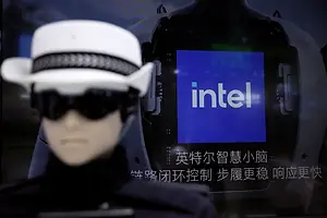 AN OUT OF FOCUS WOMAN IN A BLACK AND WHITE HAT LOOMS IN FRONT OF AN INTEL SIGN