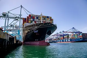 A SEA LEVEL VIEW OF CONTAINER SHIPS DOCKED AT A BUSY PORT